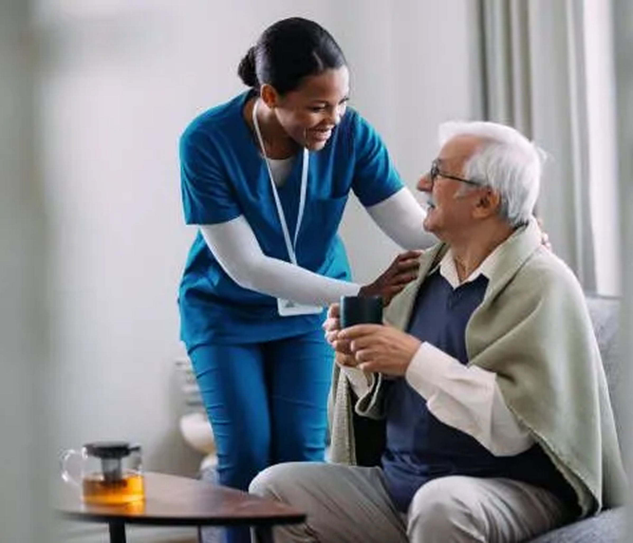 Caregiver assisting an elderly patient at home